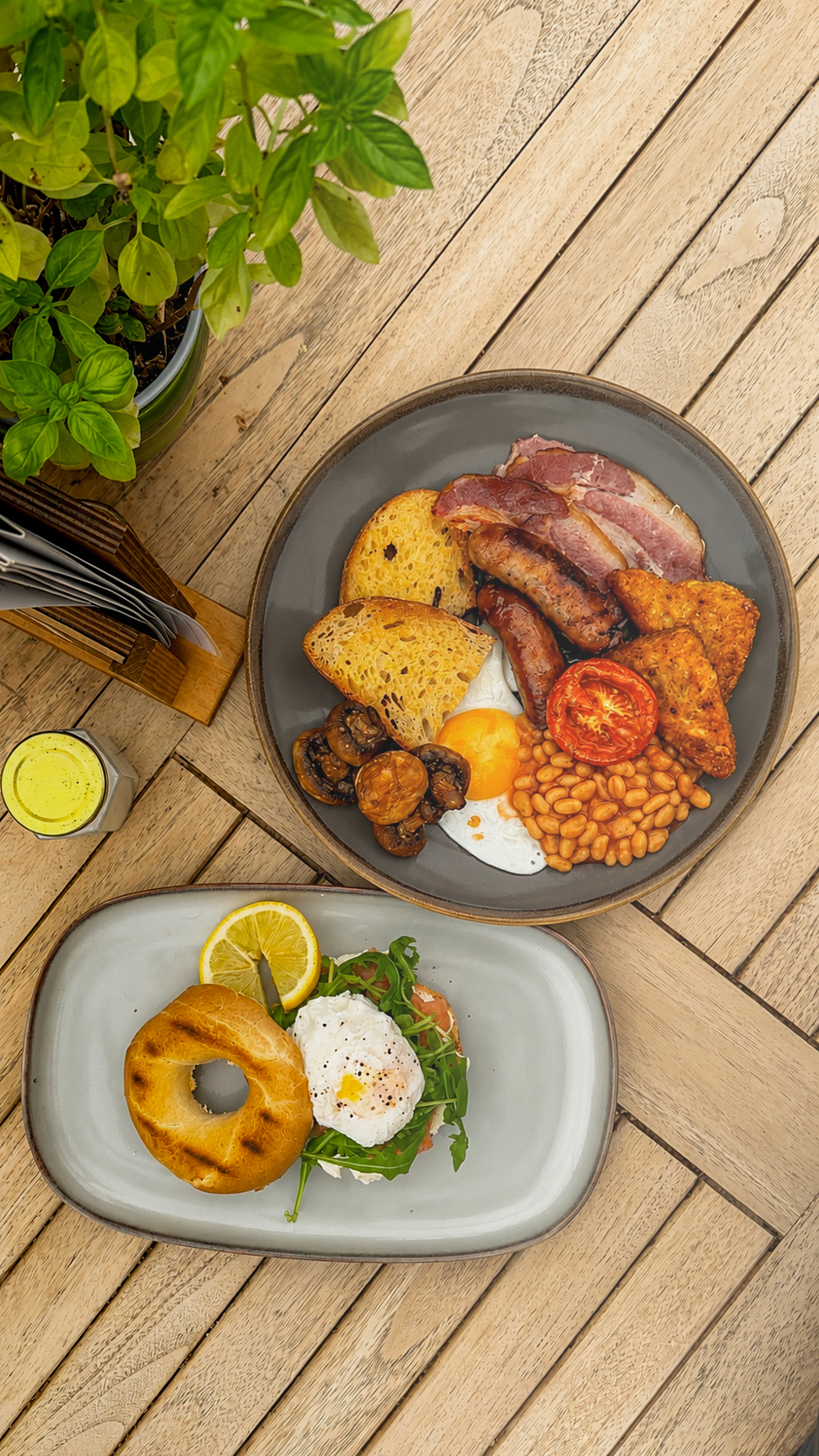 The Morning Glory breakfast with bacon, sausages, fried egg, hash browns, beans and sourdough, alongside a salmon bagel with poached egg